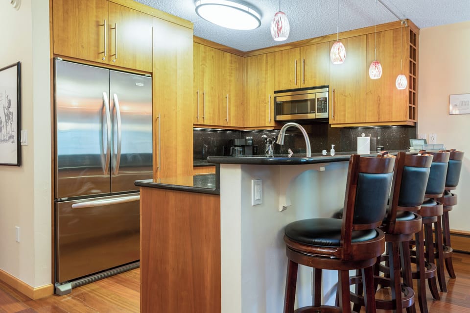 Fully stocked kitchen with granite counter tops and stainless steel appliances. 