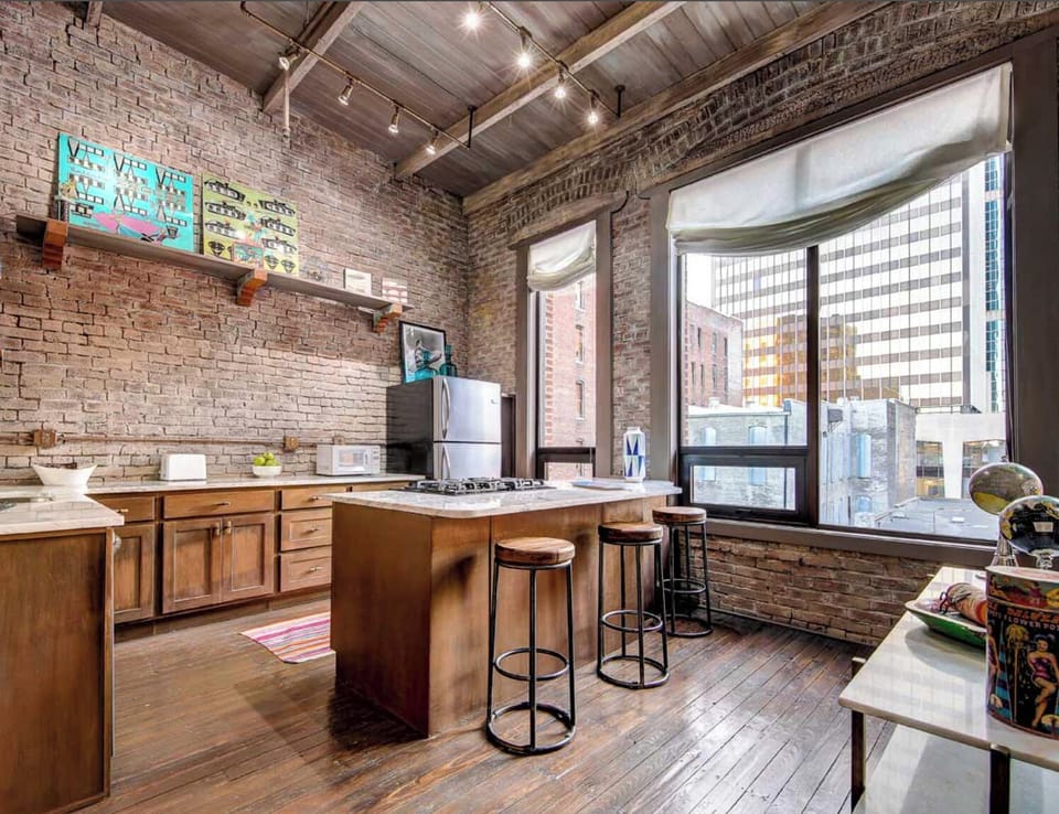 Bright Kitchen Featuring Stainless Appliances & Natural Light