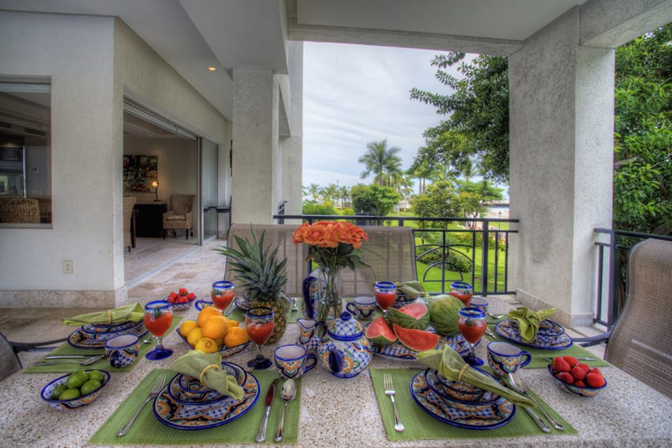 Dining on the deck with a view of the ocean and surrounding gardens.