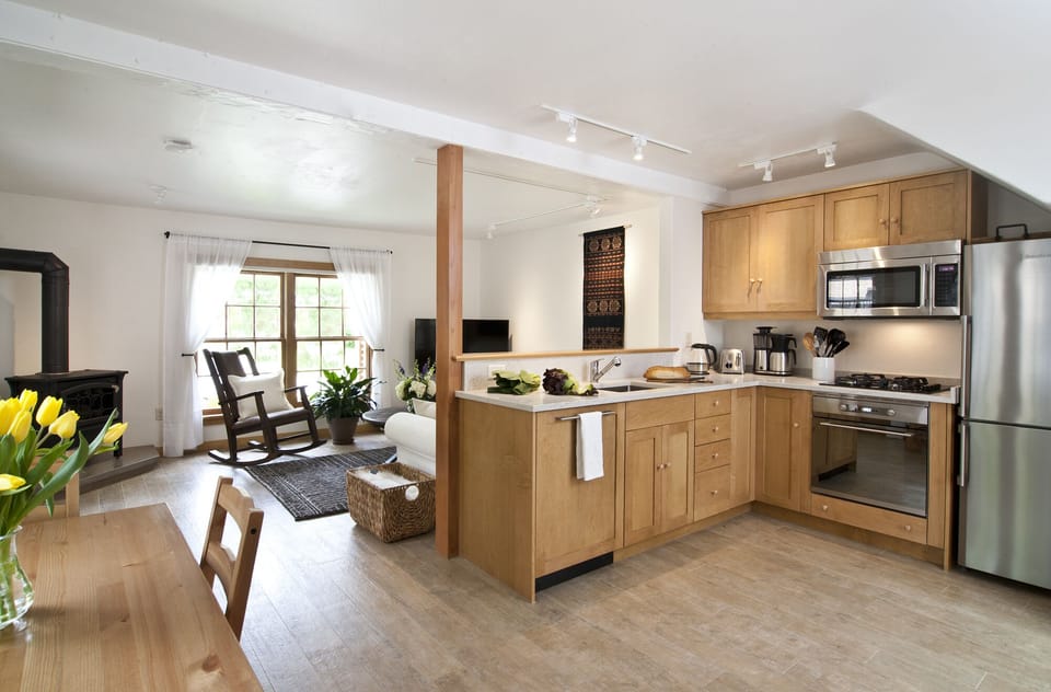 A half-wall separates the kitchen from the living room area + also connects them