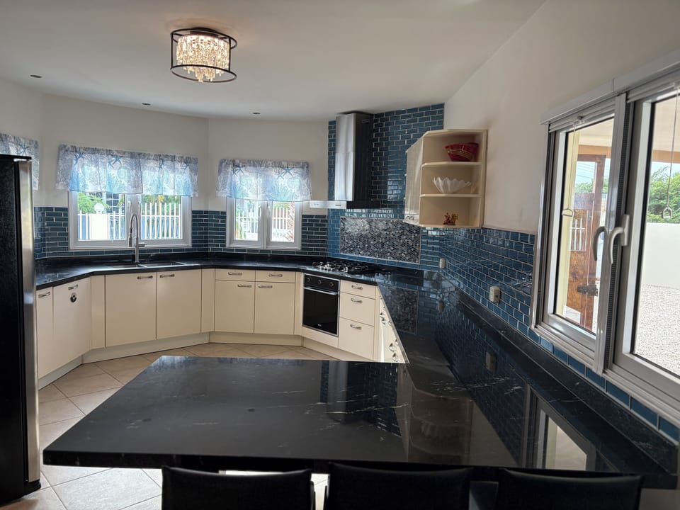 The kitchen is fully stocked w/ supplies & appliances and joins the living room.