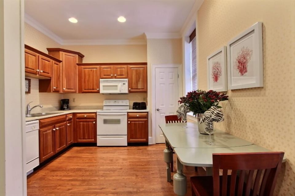 A large kitchen with utensils and cookware for you to prepare in house meals. 
