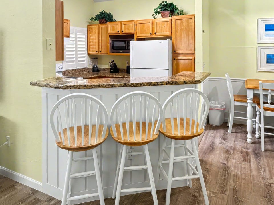 Dining Area and Kitchen.  Breakfast Bar allows for additional seating.    