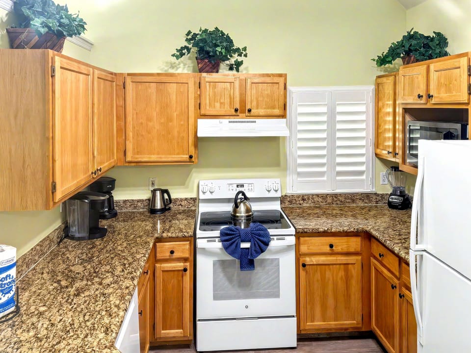 Kitchen with full sized appliances & breakfast bar.  