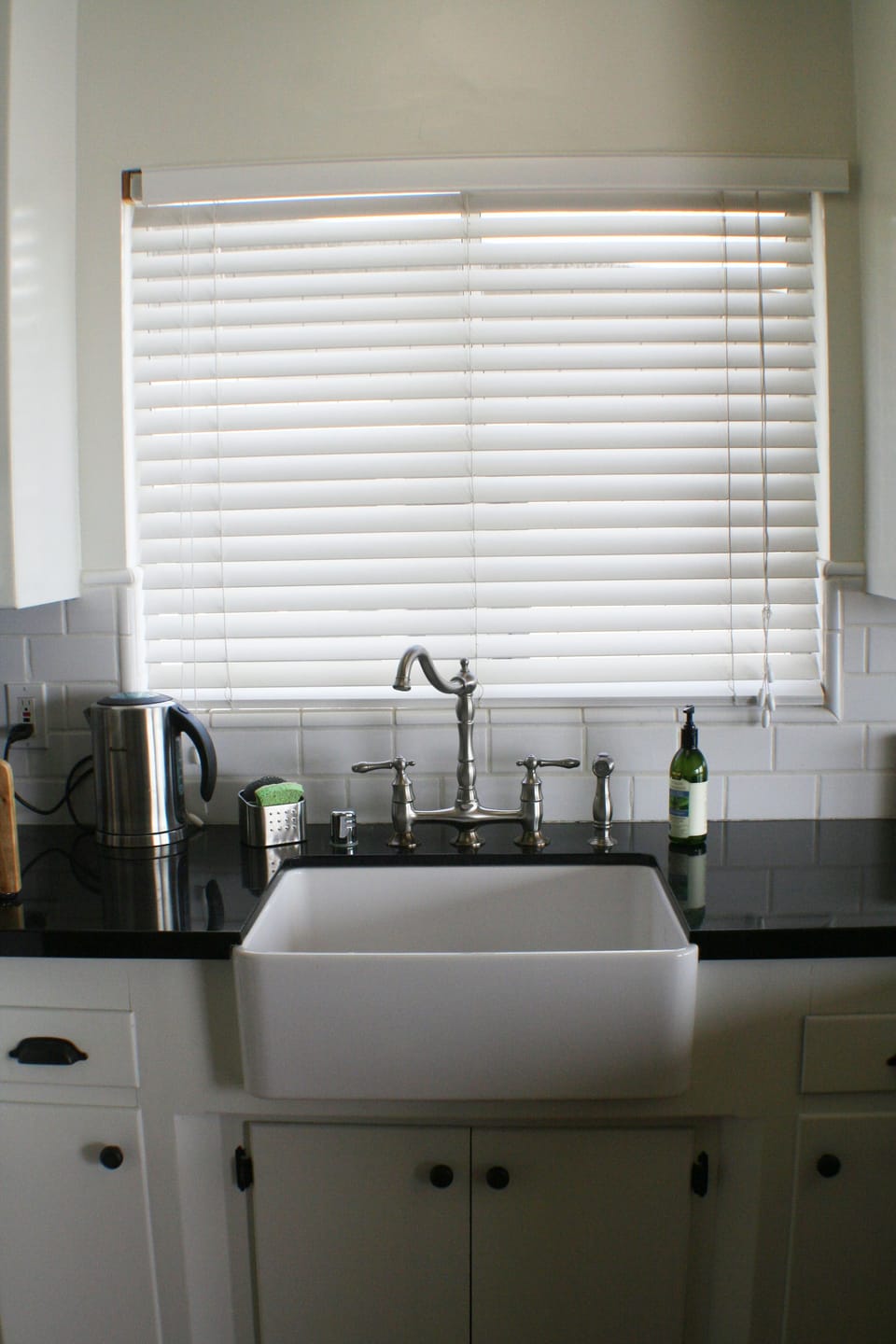 Granite counters, farmhouse sink, and dishwasher in this beautiful kitchen