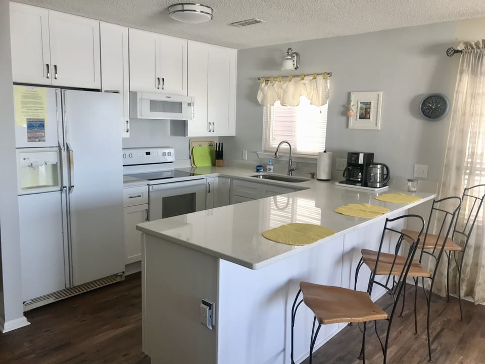Side by side refrigerator with glass pull out shelves, ice and water in door