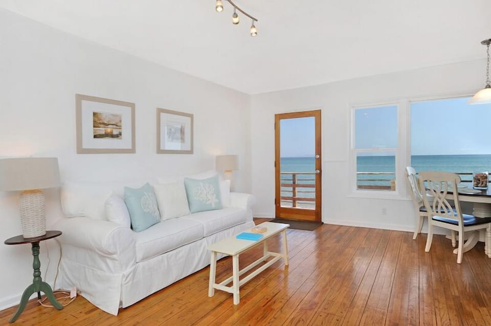 Oceanfront living area with pegged hardwood floors throughout