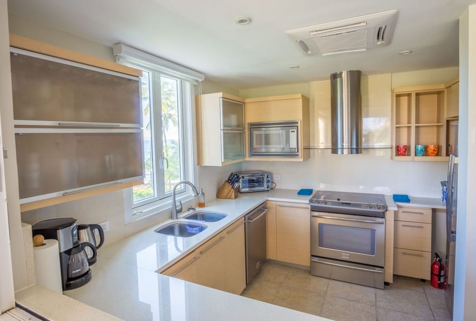 Fully-equipped modern kitchen boasts beach and golf course views.