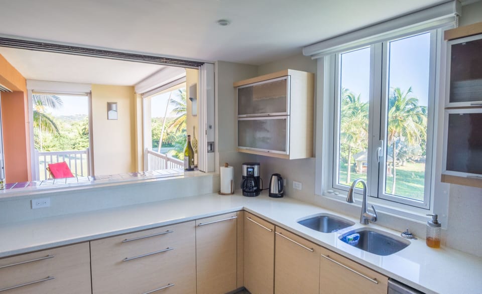 Fully-equipped modern kitchen boasts beach and golf course views.