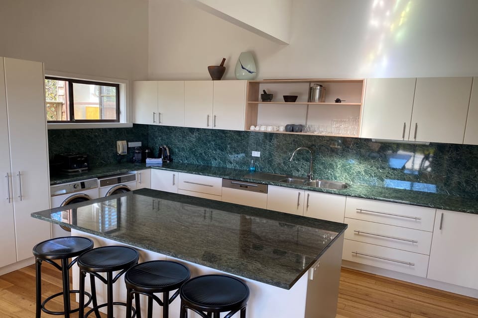 Large family kitchen also incorporates a washing machine and dryer