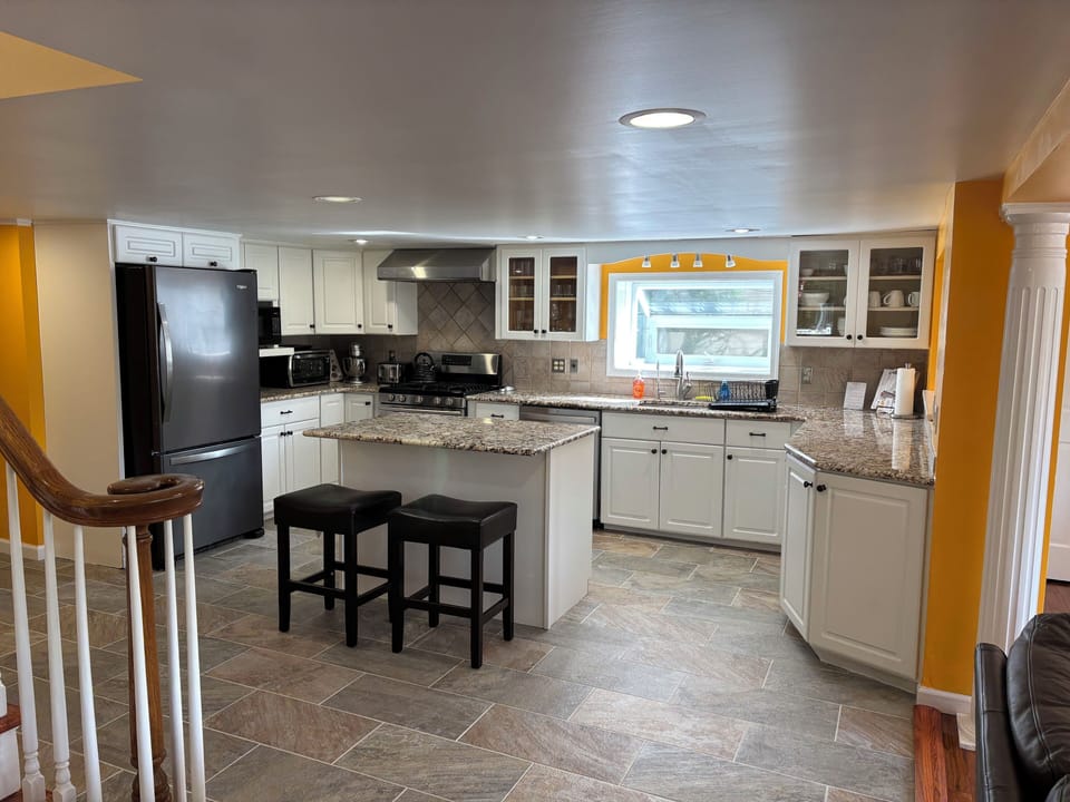 Large kitchen with appliances and cooking supplies