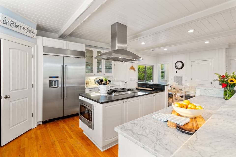 Fully stocked Kitchen with cooking island and bar area