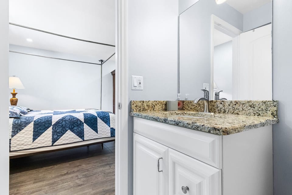 Bedroom #2 - a master bedroom with a king bed and an en-suite full bathroom