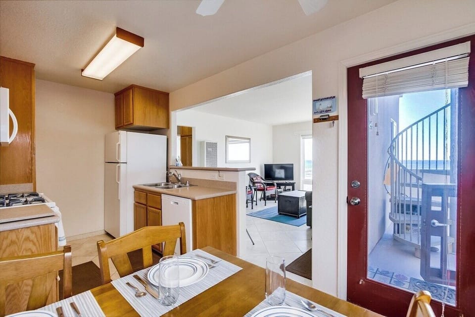 View of living room from dining table with seating for 4
