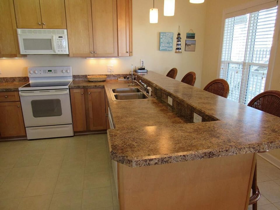 full kitchen with bar seating and dining area