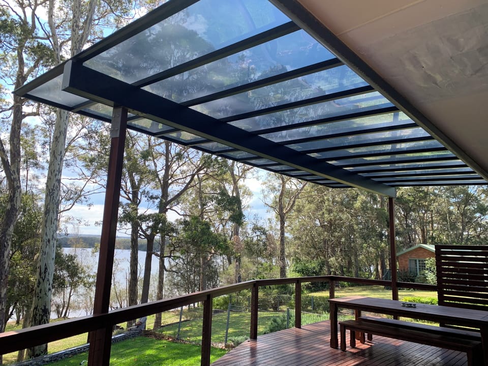 Large covered west facing deck with dining and sofas