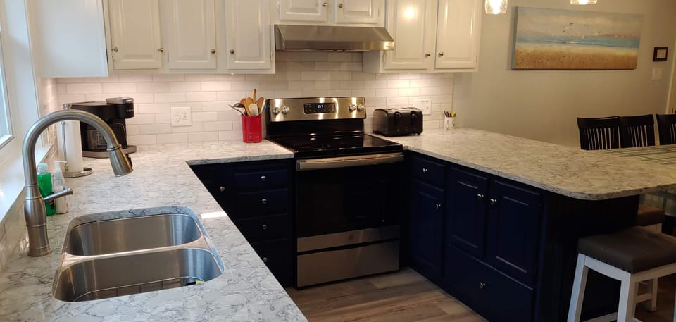 New quartz countertops, large double stainless sink, custom backsplash
