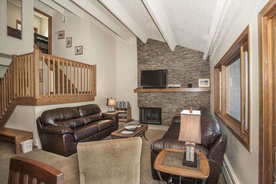 Living Room with view of stairs up to loft, bunk beds and second Master Suite
