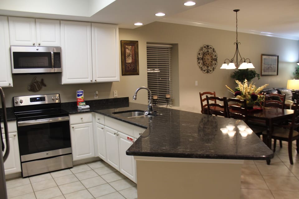 Fully equipped kitchen with stainless steel appliances and granite counter tops.