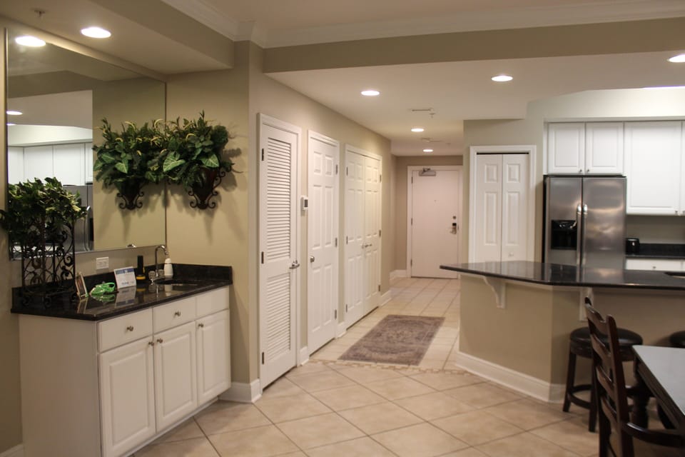 Hallway from entrance to the dining room, kitchen, laundry and wet bar.