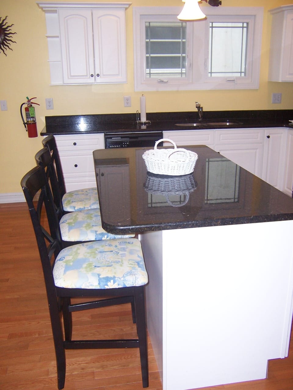 Island Kitchen with granite counters has seating for three.