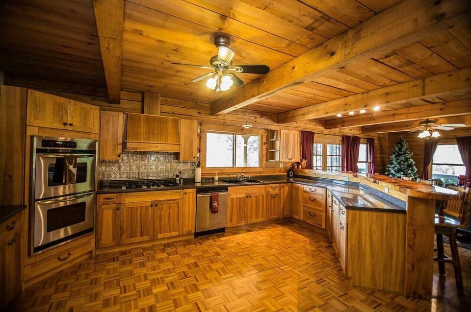 Spacious kitchen with stainless steel appliances and seating for gathering
