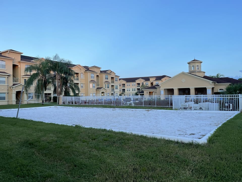 Sand beach volleyball field looking into swimming pool