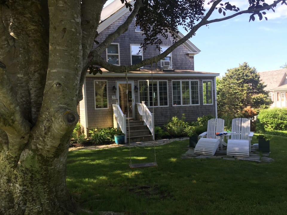 Front Of home shaded by large front yard tree afternoon 
