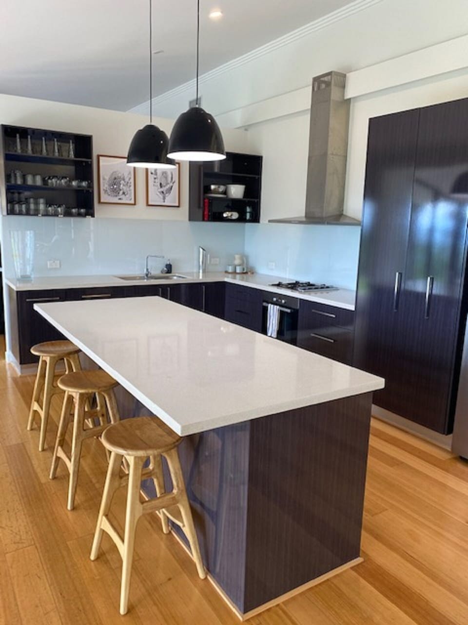 Kitchen with island bench, and under bench wine fridge