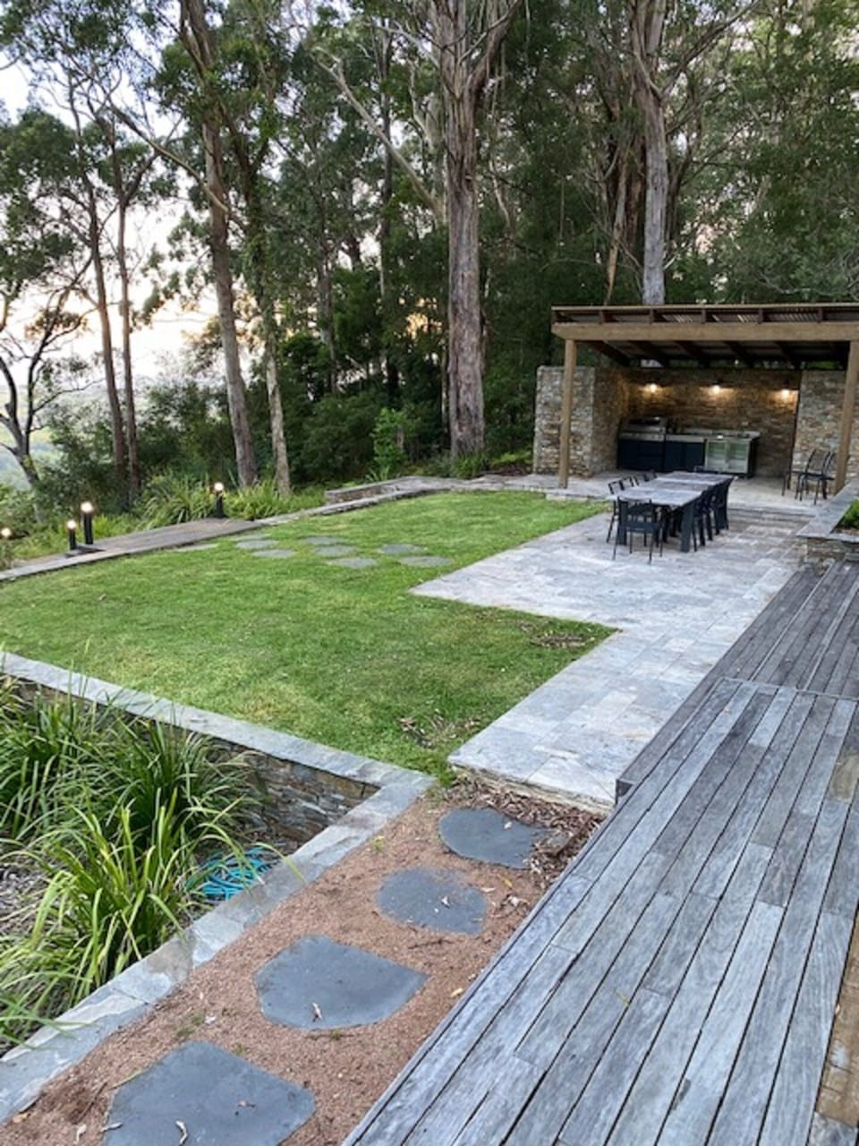 Outdoor BBQ and dining area with outdoor shower and toilet