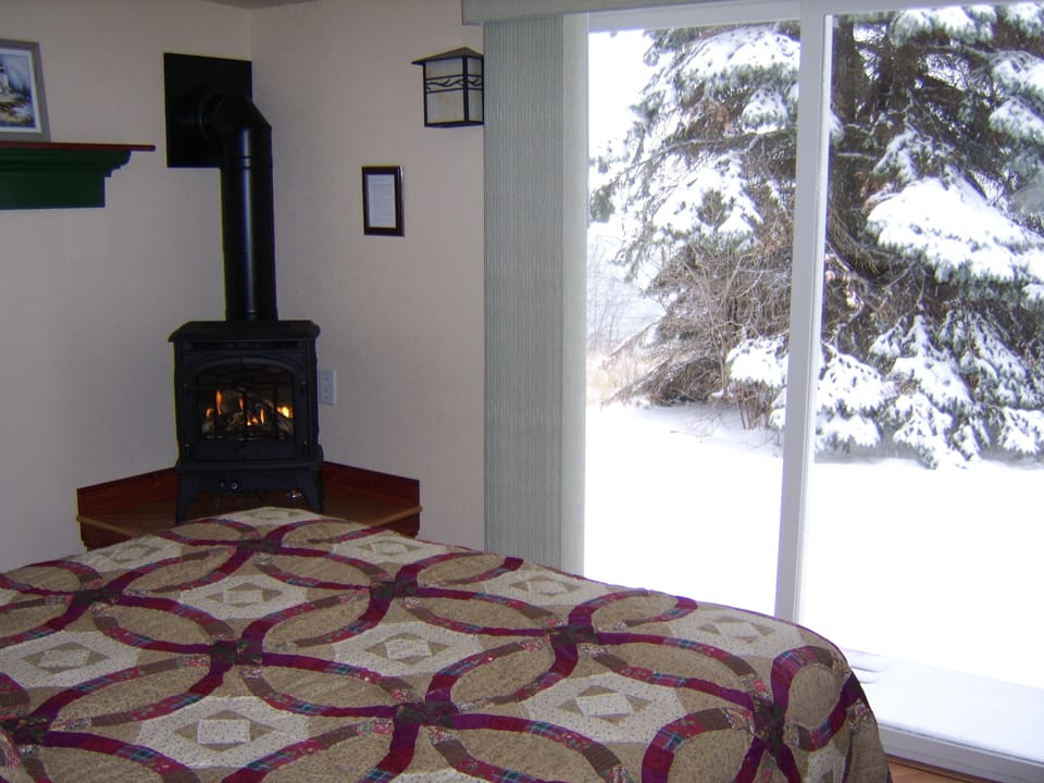 Lakeside Bedroom in Winter
It doesn't get more romantic than this. Imagine laying on the bed, warming yourself by the gas stove, and looking out at Lake Superior from Cottage #1 in the winter.