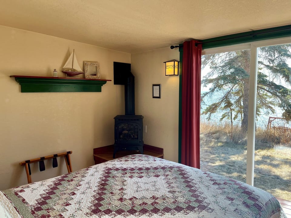 Lake Facing Bedroom
How can it get better than this. Imagine laying on the plush queen bed reading a good book with in the glow of the gas stove. As you look out the patio door you have Lake Superior laid out in front of you in Cottage #1.