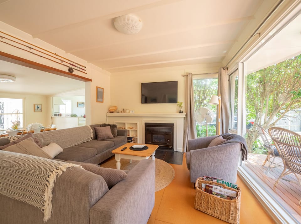 Cosy lounge with slow combustion wood heater and vintage touches