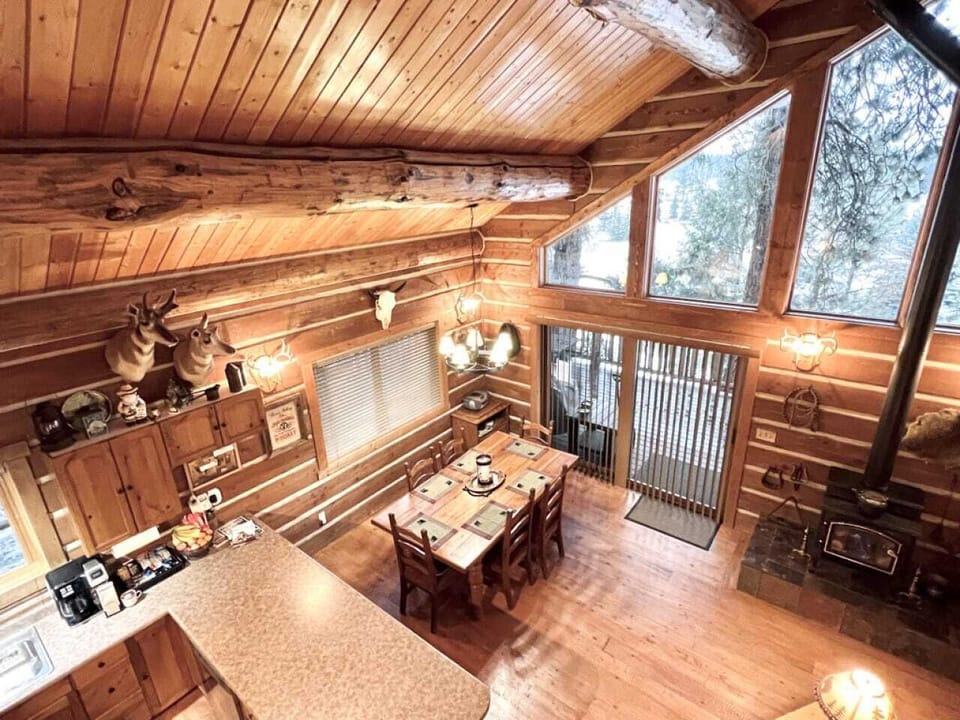 Great Room - view from upstairs loft of dining area and kitchen with gas stove, and exterior deck access