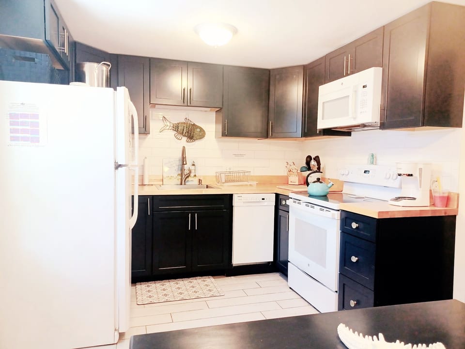 new kitchen with navy cabinets