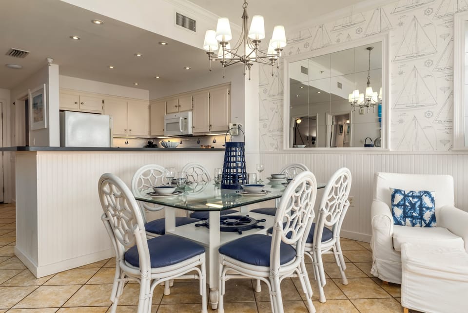 Gather around your elegant dining table in this bright, coastal-inspired space where nautical charm meets modern comfort for memorable meals together.
