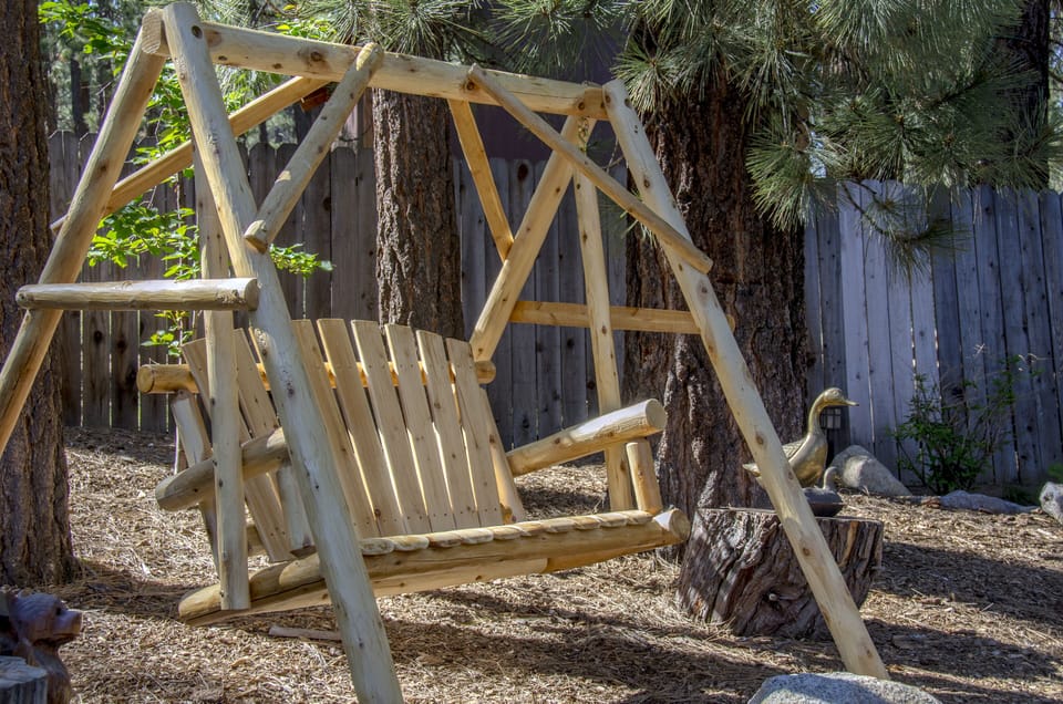 Relax out back in the log swing. The backyard is fully fenced-in! 