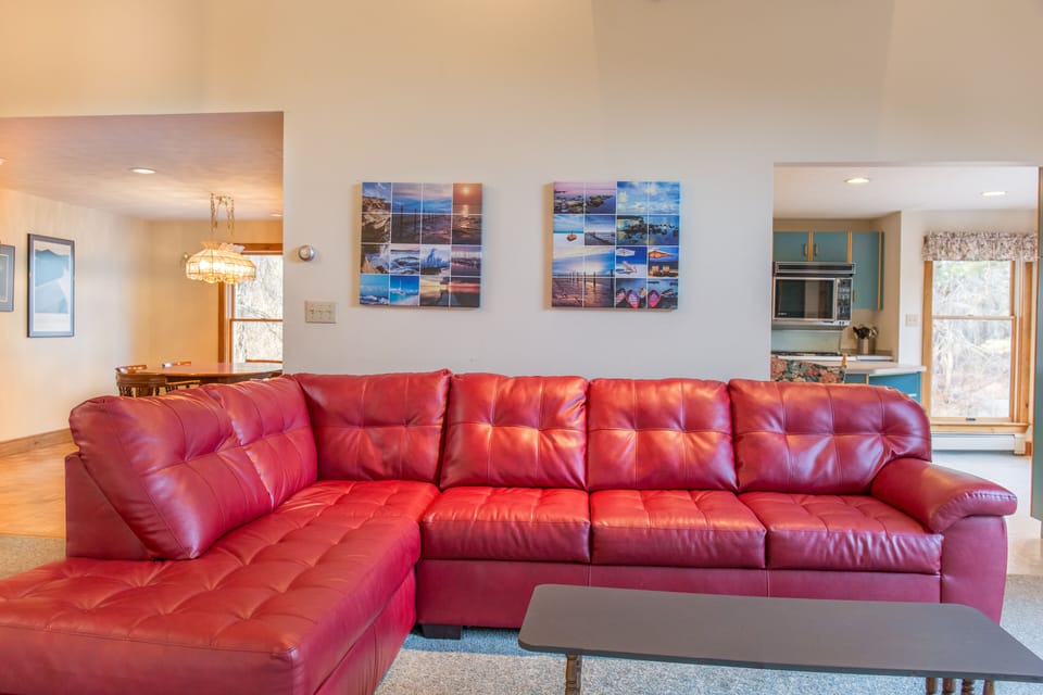 Living area couch, kitchen to the right, dining to the left.