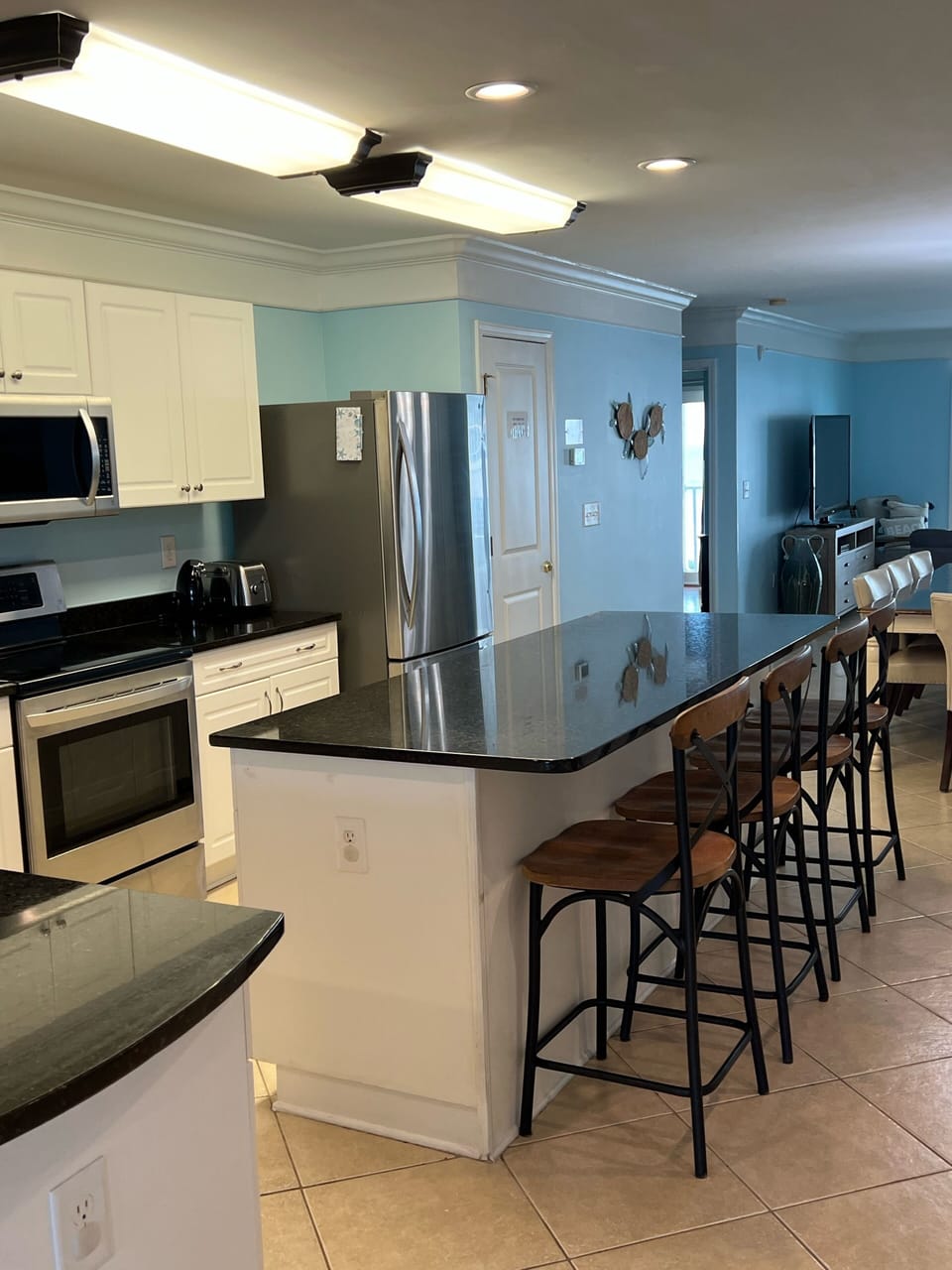 Large kitchen with stainless appliances. 