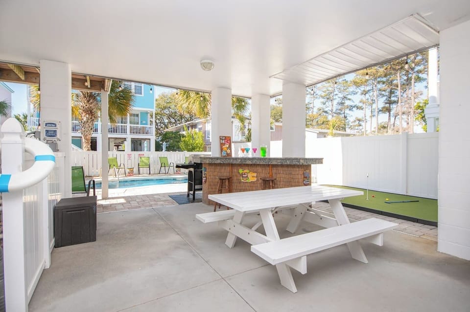 Backyard vibes turned all the way up! Sip, snack, or chill under the sun-or-shade setup beside your very own tiki bar.