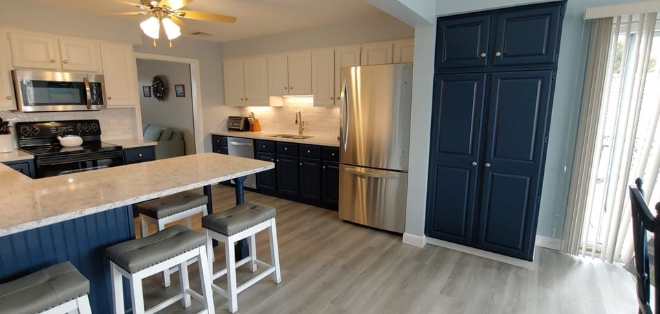 Large pantry with fold out shelves, sliders to deck with grill/pool.
