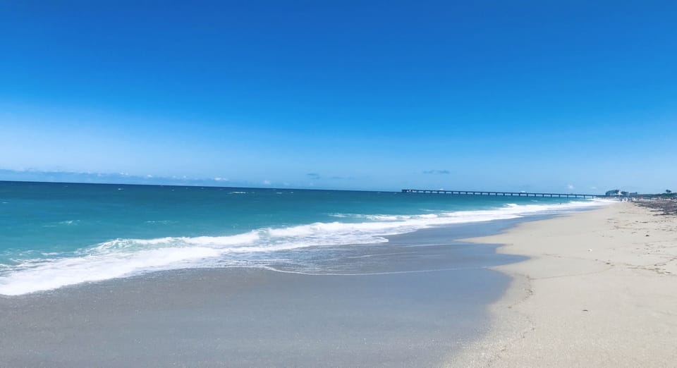 Your actual beach arrival view, looking south toward iconic Juno Beach Pier.