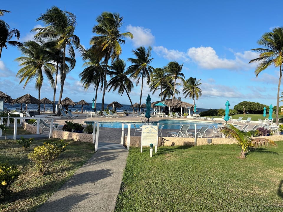 Large beachfront swimming pool with spacious sun deck and poolside beach bar
