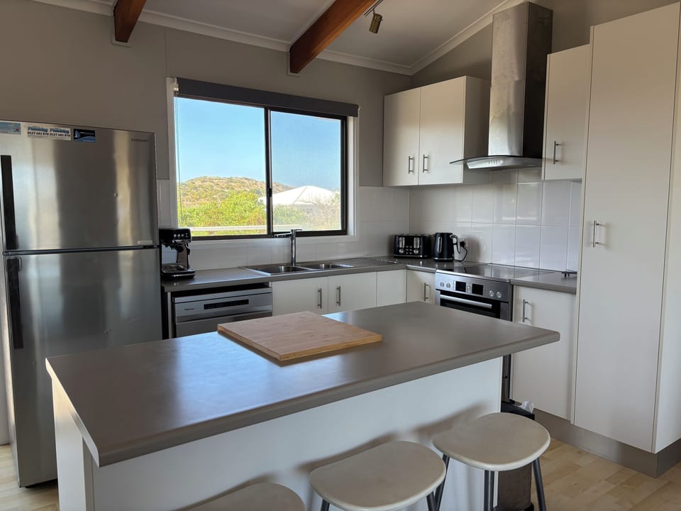 Sociable kitchen with breakfast bar and bar stools.