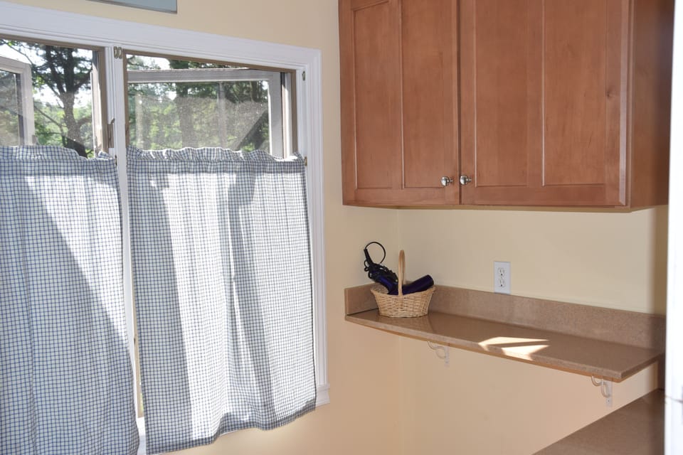 Remodeled bathroom cabinets and shelf for guest toiletries (east windows)