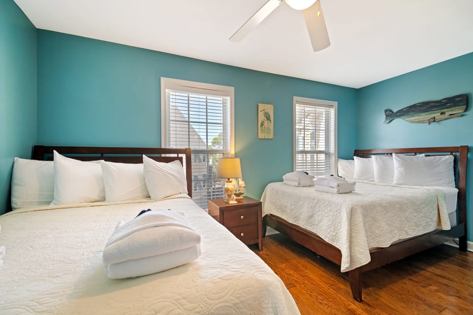 Guest bedroom upstairs featuring two Double beds, a TV and ensuite bathroom.