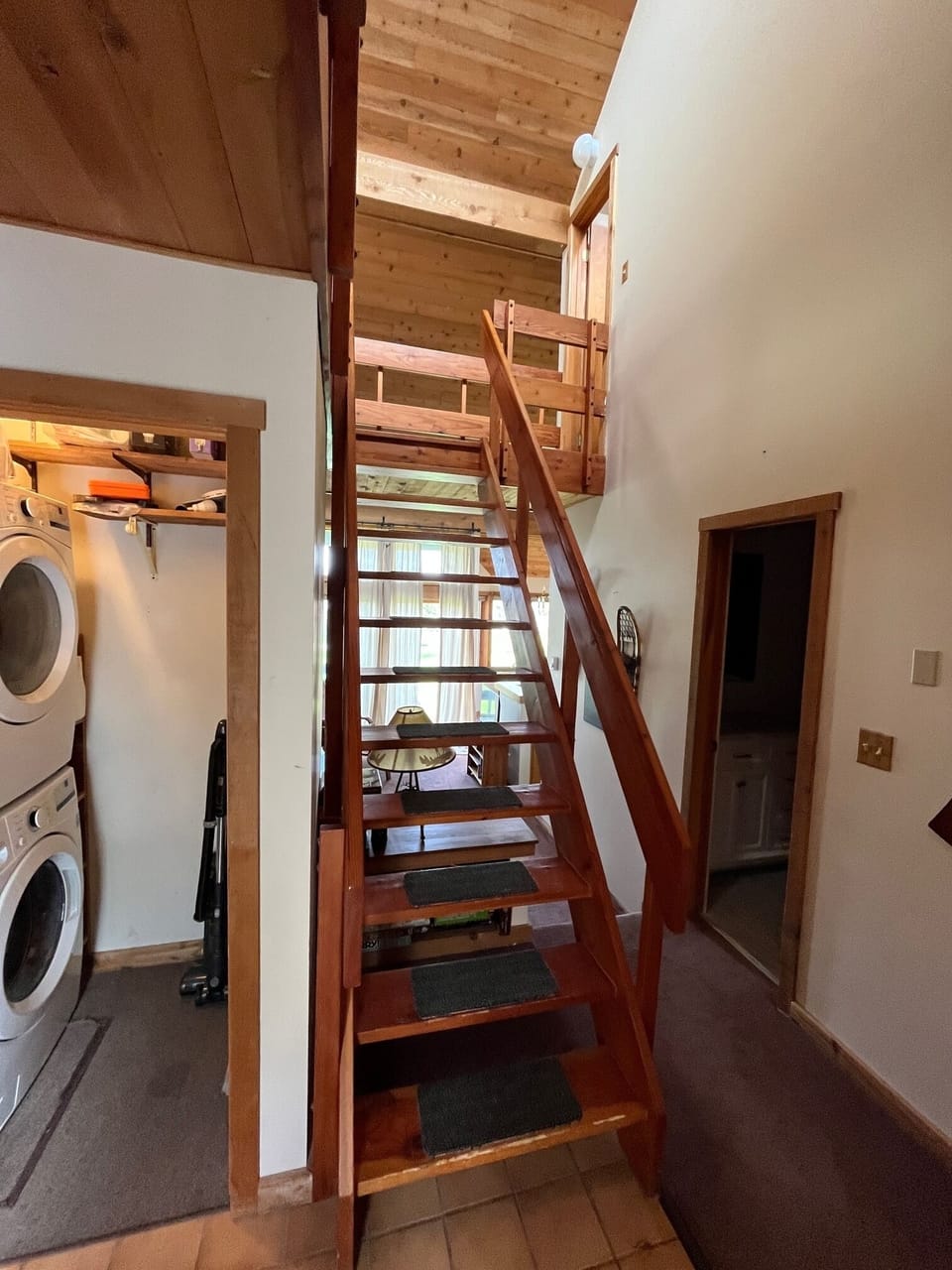 Stairs up to loft showing hall bath and laundry room