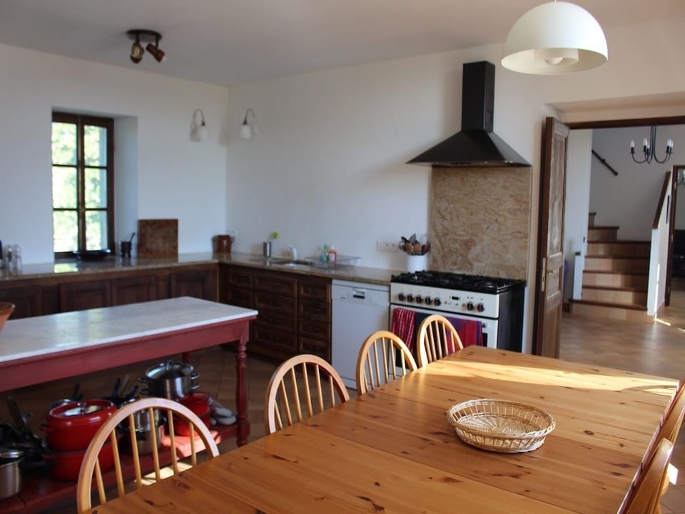Part of the kitchen table (sits 16) looking through to upstair hall & livingroom