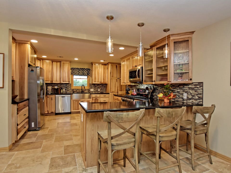 Kitchen with Granite Counter Top, Wine Cooler, and Laundry.