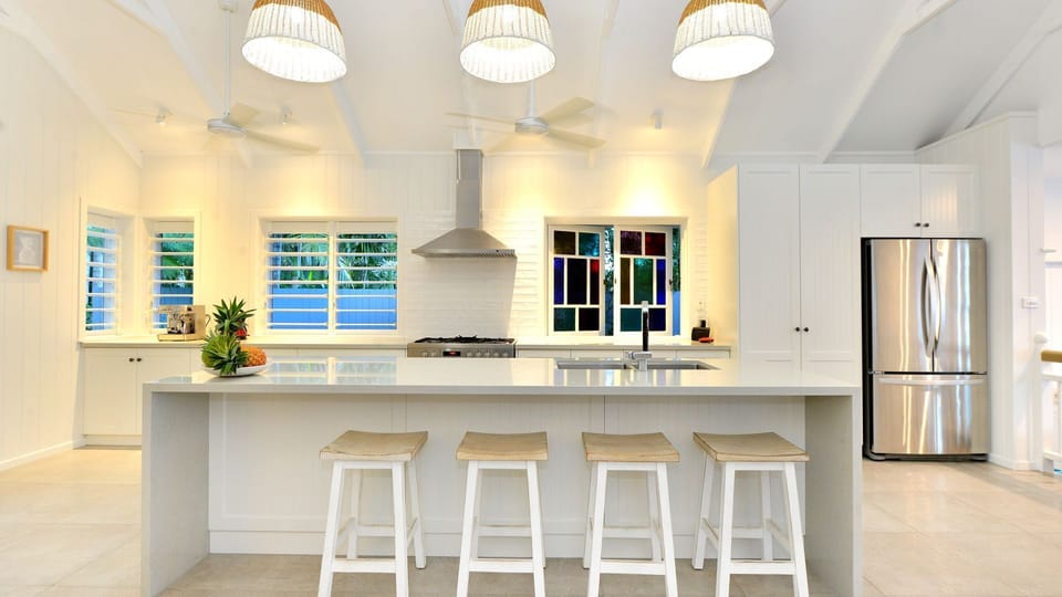 Beautiful high ceiling kitchen area with original Queenslander stainglass window
